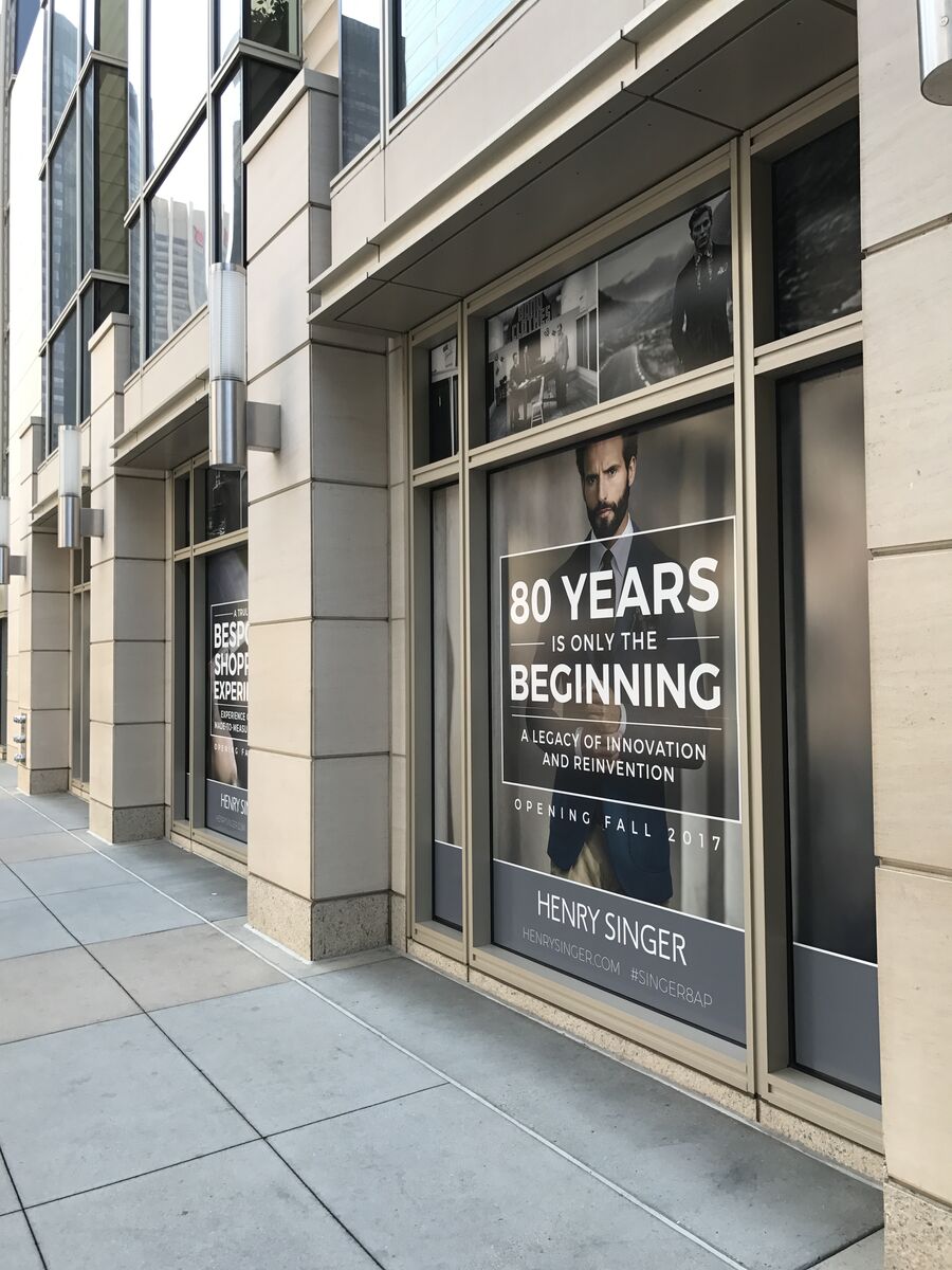 80 Years Is Only the Beginning window wrap on the street